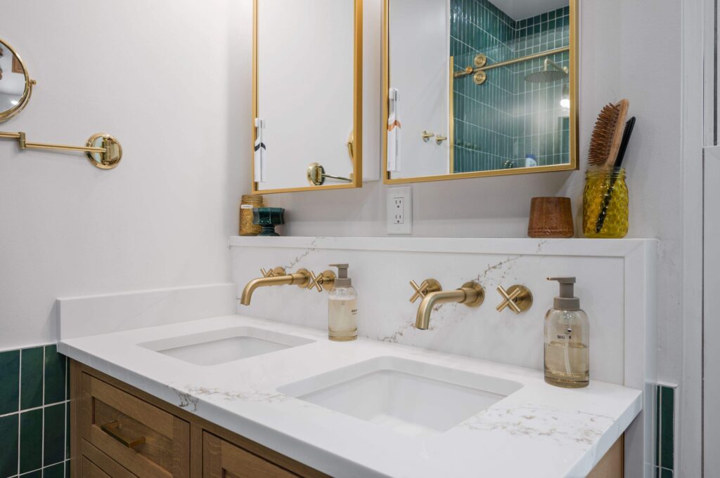 Double vanity with gold wall faucets