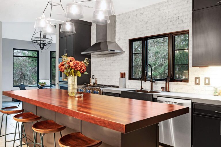 Kitchen with a wood-top island and a black sink